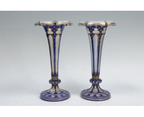 A fine pair of Bohemian overlay glass vases, late 19th century each of elongated trumpet shape form with a folded gilt rim, t