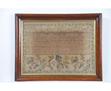 An early 19th Century embroidered sampler, of rectangular form, the central field embroidered with twelve lines of religious 