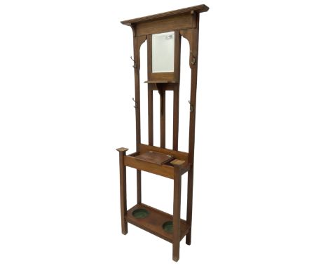 Edwardian oak hall stand, raised back with rectangular bevelled mirror plate surrounded by shelf and coat hooks, fitted with 