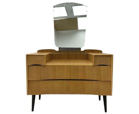  Mid-20th century light oak dressing table, raised shaped mirror back over two short and two long drawers, on splayed and tap