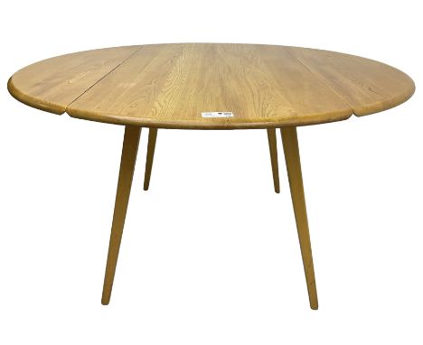 Ercol - mid-20th century light elm and beech drop-leaf dining table, circular top over splayed supportsDimensions: Height:&nb