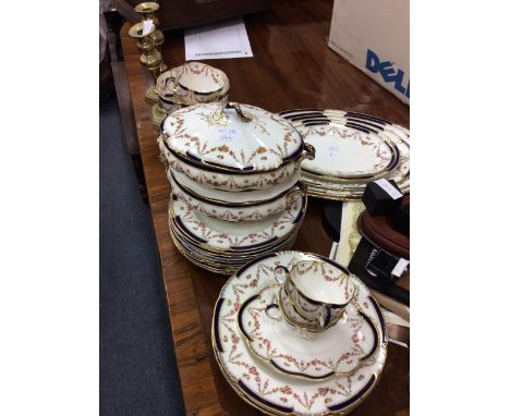 A PART DINNER SERVICE retailed by Maple &amp; Co with a graduated set of five meat platters, the largest 43cm wide, with four