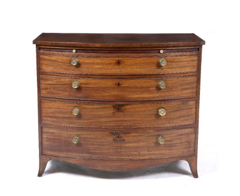 AN EARLY 19TH CENTURY MAHOGANY BOW FRONTED CHEST OF FOUR GRADUATED DRAWERS beneath a baize inset brushing slide, all standing