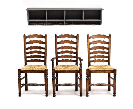 A SET OF THREE OAK LADDER BACK DINING CHAIRS with rush seats by Brights of Nettlebed, consisting of an armchair, 55.5cm wide 