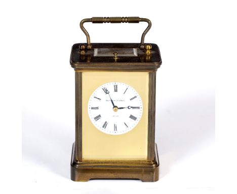 A LATE 20TH CENTURY BRASS CARRIAGE CLOCK by Matthew Norman of London, the circular enamel dial with roman numerals and signat