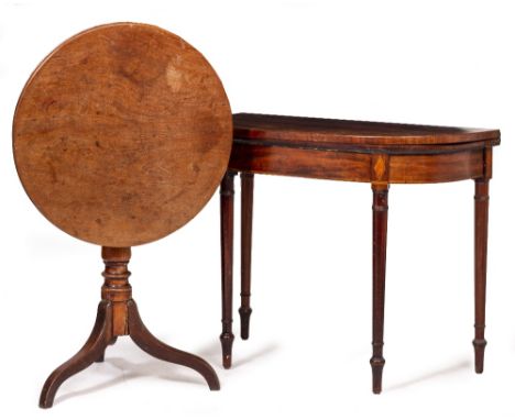 A GEORGE III MAHOGANY FOLD OVER CARD TABLE with cross banded top and turned tapering legs together with a circular mahogany t