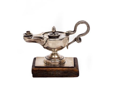 A VICTORIAN TABLE LIGHTER in the form of an oil lamp with a pineapple finial, serpent handle and mounted on wooden base, make