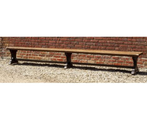 A VICTORIAN OAK BENCH with outset octagonal decorative columns to the shaped supports united by stretchers, 366cm long x 34cm