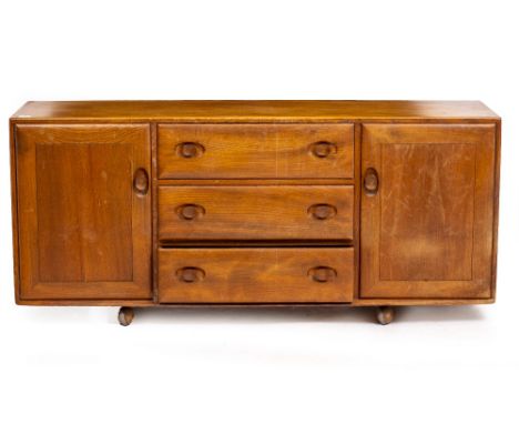 AN ERCOL LIGHT ELM SIDEBOARD CABINET with three central drawers flanked by cupboards, 156cm wide x 44cm deep x 68cm high Cond