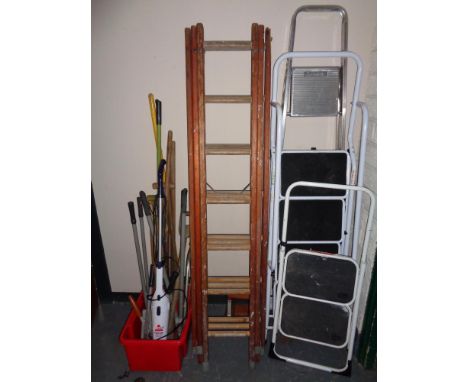 A wooden triple section extension ladder 