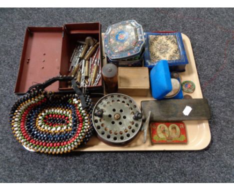 A tray of vintage cash box and tins, beaded purse, bullet casings, costume jewellery, Ever Ready Dam fishing reel, cylindrica