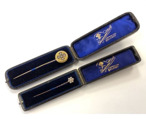 A boxed 15ct gold, pearl and enamel stick pin, together with another diamond and pearl pin (2)