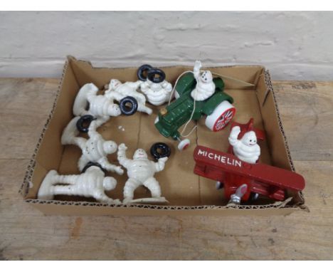A box of six assorted Michelin man figures -tractor and bi-plane etc.