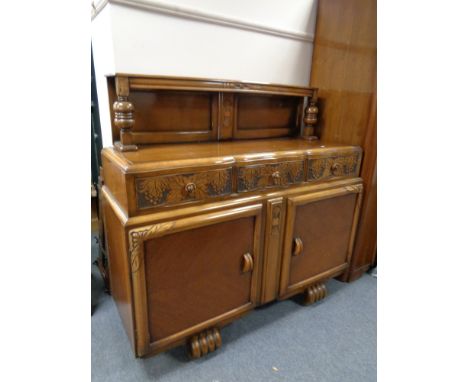 A carved oak buffet back sideboard 