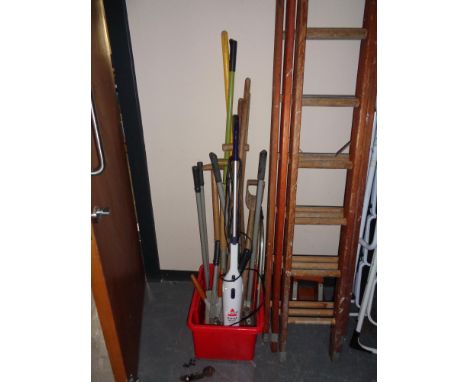 A plastic tub of garden tools and a Bisel bagless vac cleaner 