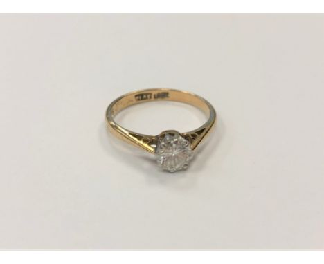 An 18ct gold and platinum diamond solitaire ring, the brilliant cut stone weighing approximately 0.40 carat, size J1/2.