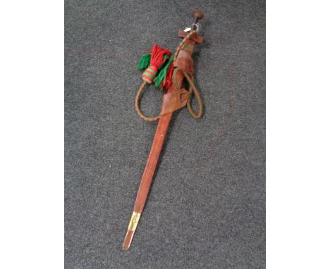 A Sudanese Kaskara style sword in leather scabbard with rope strap 