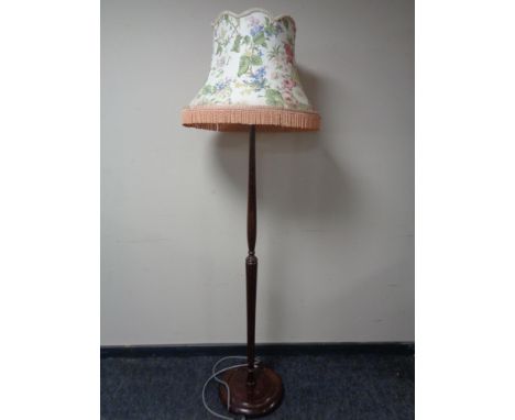 An early 20th century standard lamp with tasseled shade 
