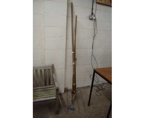 Two vintage hay forks together with two other tools