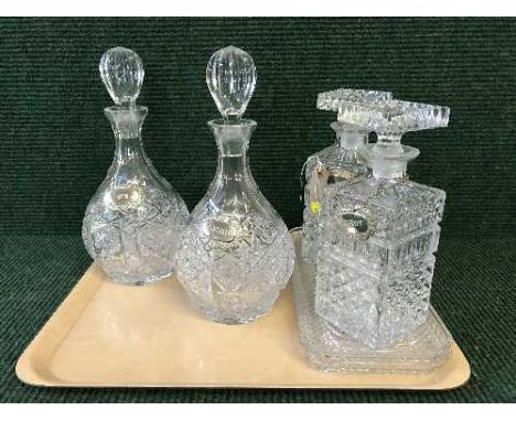 A tray of four decanters with labels and two trinket trays 