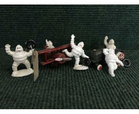 A cast metal figure - Michelin man in plane, Michelin man on traction engine and three cast metal Michelin man figures 