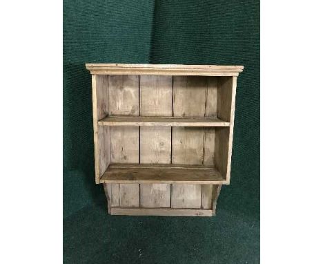 A rustic pine wall shelf