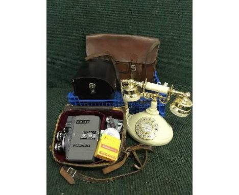 A crate of leather satchel, vintage style telephone, cine camera etc 