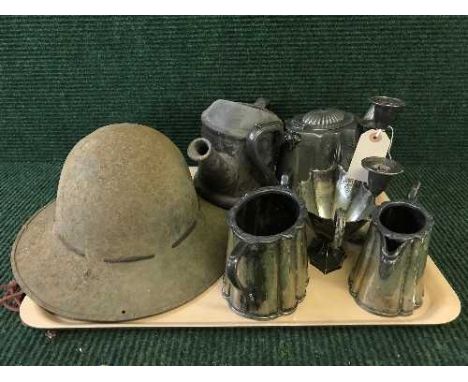 A tray of WW I helmet, plated ware, pottery watering can 