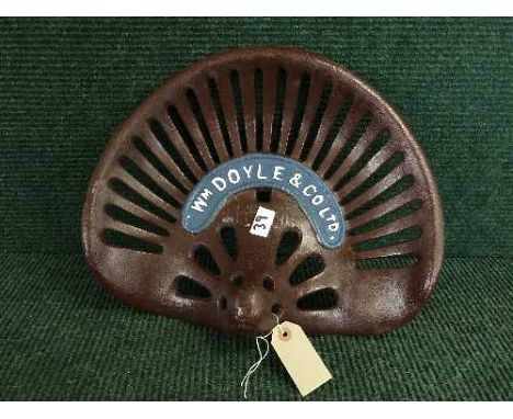 A cast metal W M Doyle tractor seat