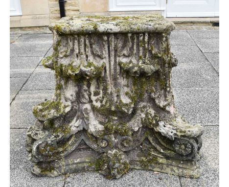 A Weathered Stone Corbel, in the form of a corinthian column cap, 104cm by 49cm by 76cm