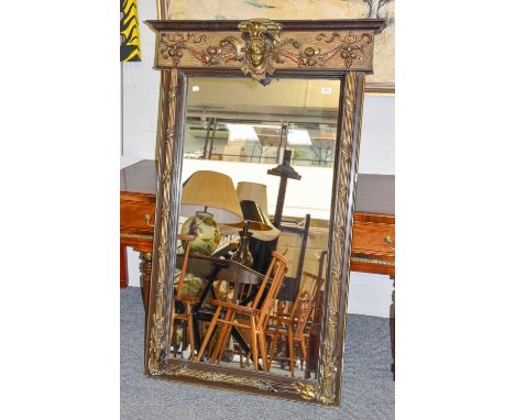 A Large Rectangular Wall Mirror, early 20th Century, parcel gilt, adorned with a portrait bust, fruit festoons and with flute