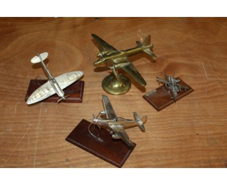 Three silver model aeroplanes and a brass model aeroplane (4)