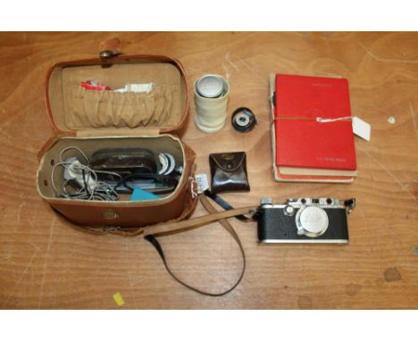 Leica Model III camera with chrome-finished metal parts, 50mm Elmar and Elmar 9cm long focus lens and other equipment, in a c