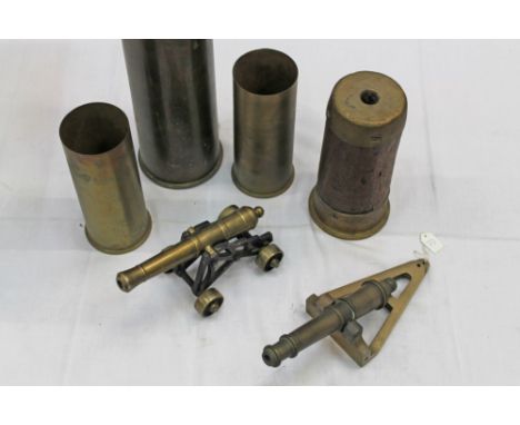 Two decorative model cannons, together with a selection of brass shell cases