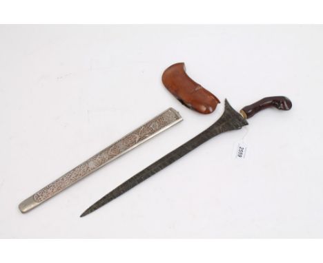 19th century kris with watered steel blade in white metal mounted scabbard