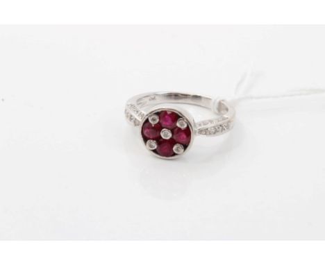 White gold (18ct) ruby and diamond ring with four round mixed cut rubies and five interspaced diamonds in a circular setting,