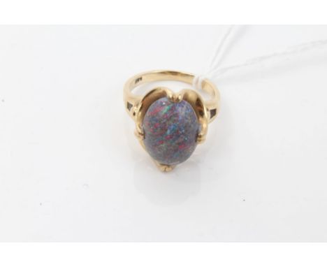 Opal single stone ring set with an oval cabochon black opal in yellow metal setting (stamped 14k).  Ring size M