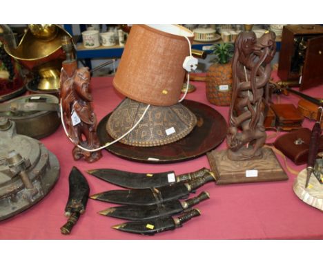 Chinese carved hardwood figure lamp, Indian carved wooden dragon lamp, Japanese lacquer tray, two Chinese hats and five kukri