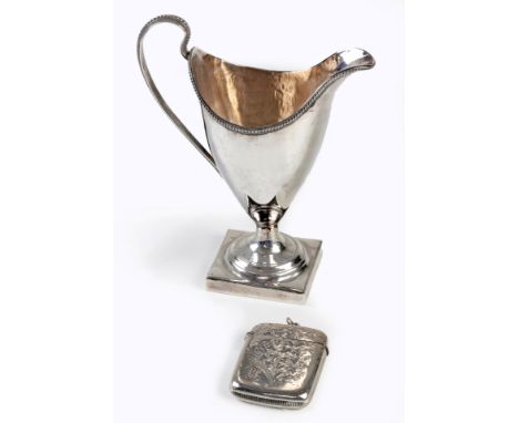 A SILVER VESTA CASE, BIRMINGHAM regtangular, chased with leaf decoration throughout, 29g; and a Silver Milk Jug, London 1825,