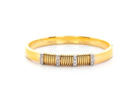 A DIAMOND BANGLE hinged, centred with 4 bands of diamonds, each comprising 3 pavé-set round brilliant-cut diamonds, weighing 