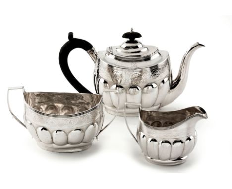 A GEORGE III THREE-PIECE SILVER TEA SERVICE, HENRY SKIDMAN, LONDON, 1802 comprising: a teapot, sugar basin and milk jug, of o