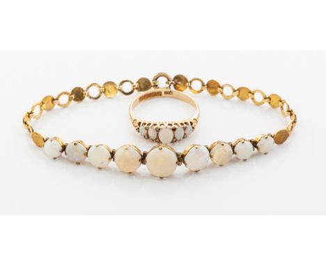 AN OPAL BRACELET designed as a graduating row of 9 claw-set cabochon opals flanked by alternating gold discs and rings, in 18