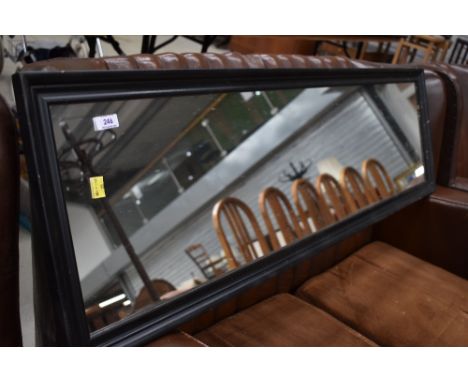 A modern black frame full length wall mirror