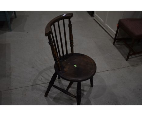 A traditional solid seat kitchen dining chair having turned and stick back