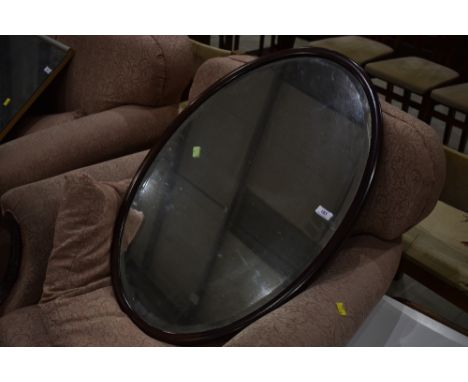 An early 20th Century mahogany oval wall mirror, width approx. 79cm