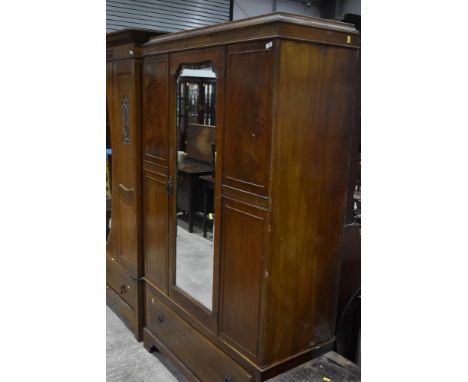An early 20th Century mahogany mirror door wardrobe having drawer base, width approx. 120cm
