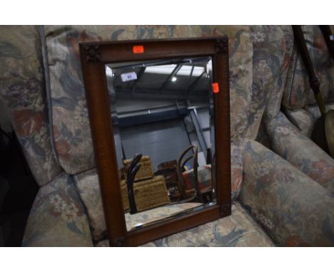 An Arts and Crafts oak wall mirror, labelled on reverse for Arthur Simpson Handicrafts of Kendal, impressed number 8350, appr