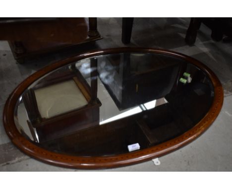 An Edwardian mahogany and inlaid oval wall mirror, approx 87 x 62cm