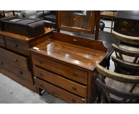 An early 20th Century oak dressing table, having shaped mirror back over three drawers, width approx. 92cm