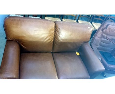 A brown leather 2 seat sofa